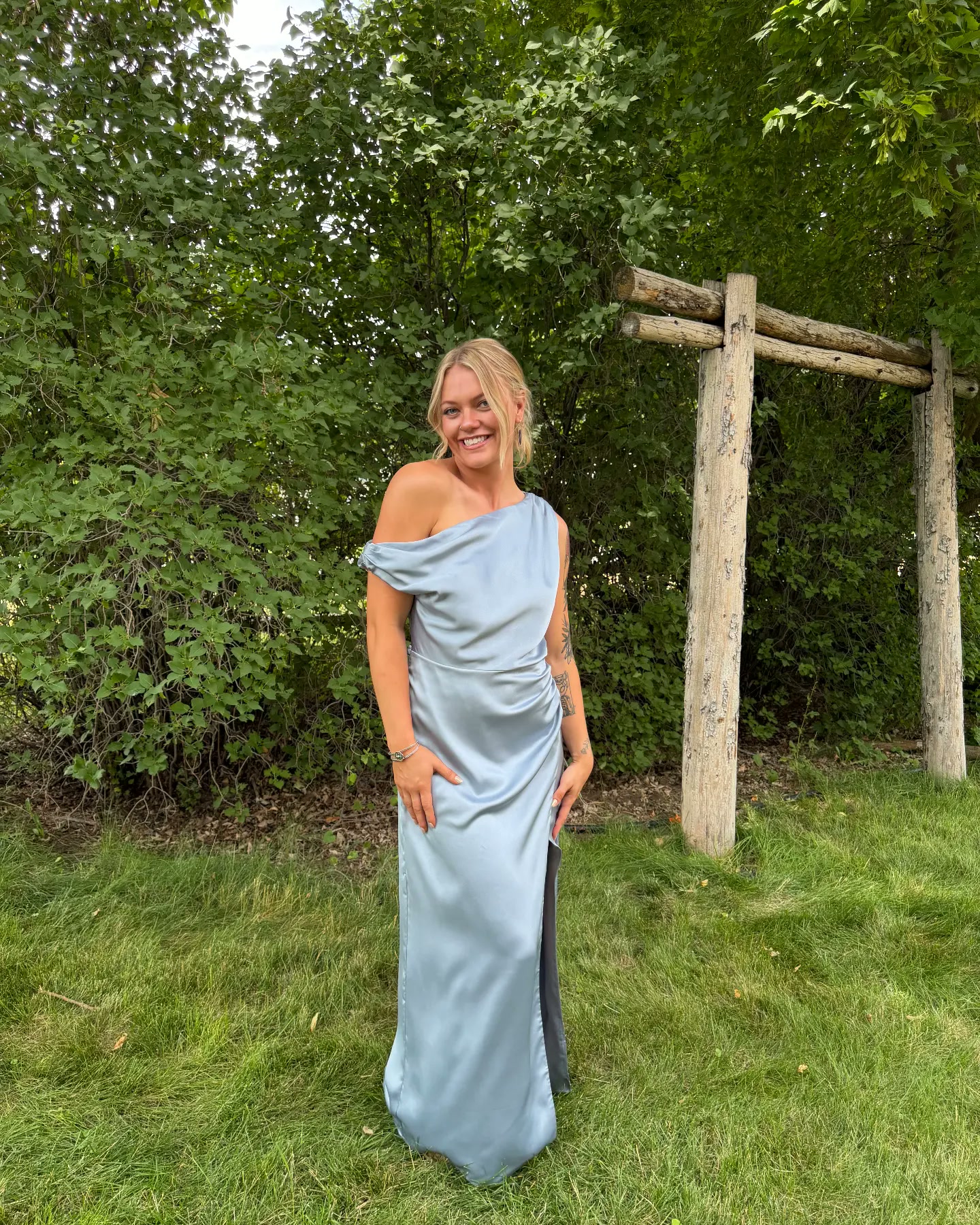 Haley smiling outside in a blue dress